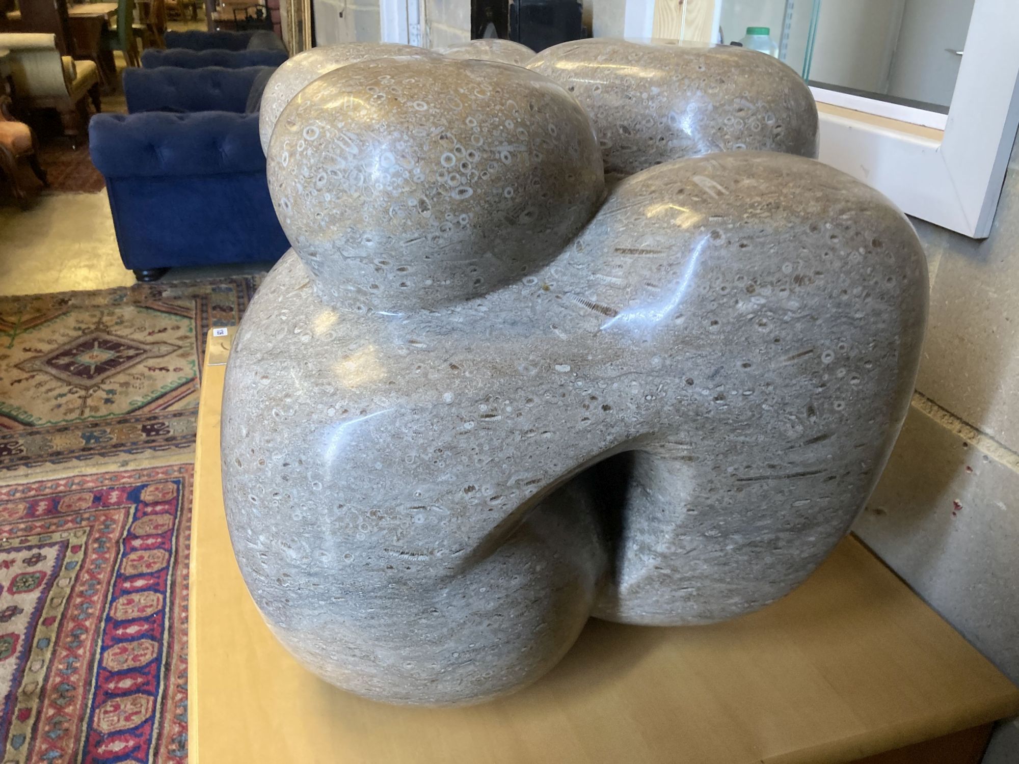 § Polly Ionides (born 1944) Triune, An abstract figural carved limestone group, width 106cm, depth 50cm, height 50cm